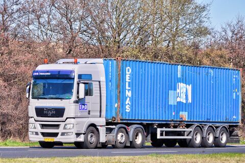 Truck hauling a shipping container by road